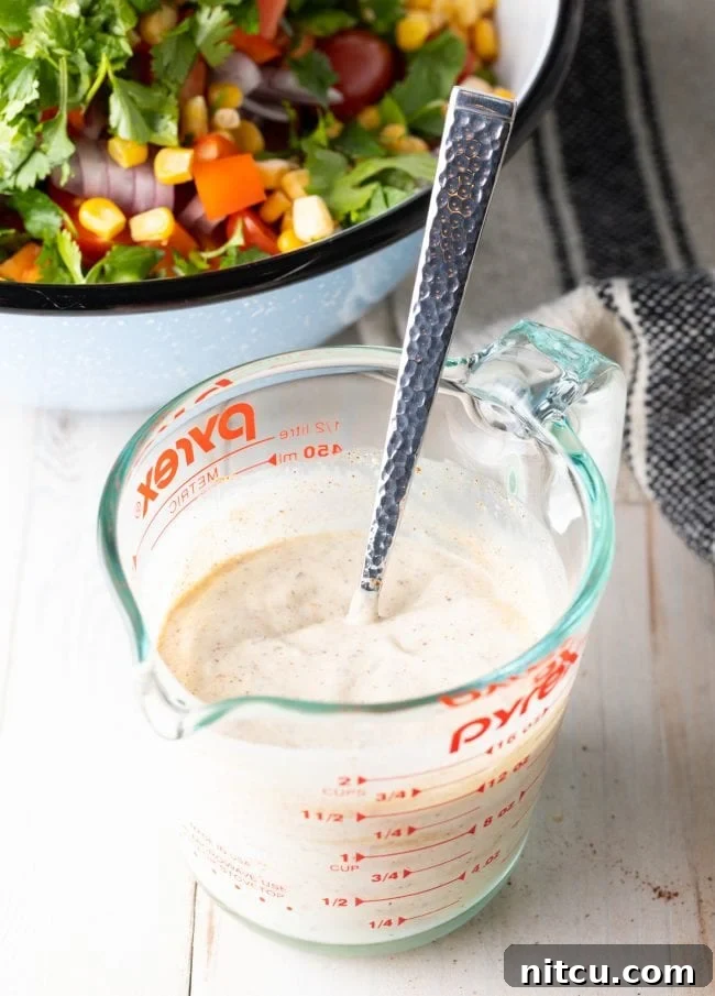 Fiesta Pasta Salad 7 Close-up of creamy southwest ranch dressing in a bowl, showing its rich texture.