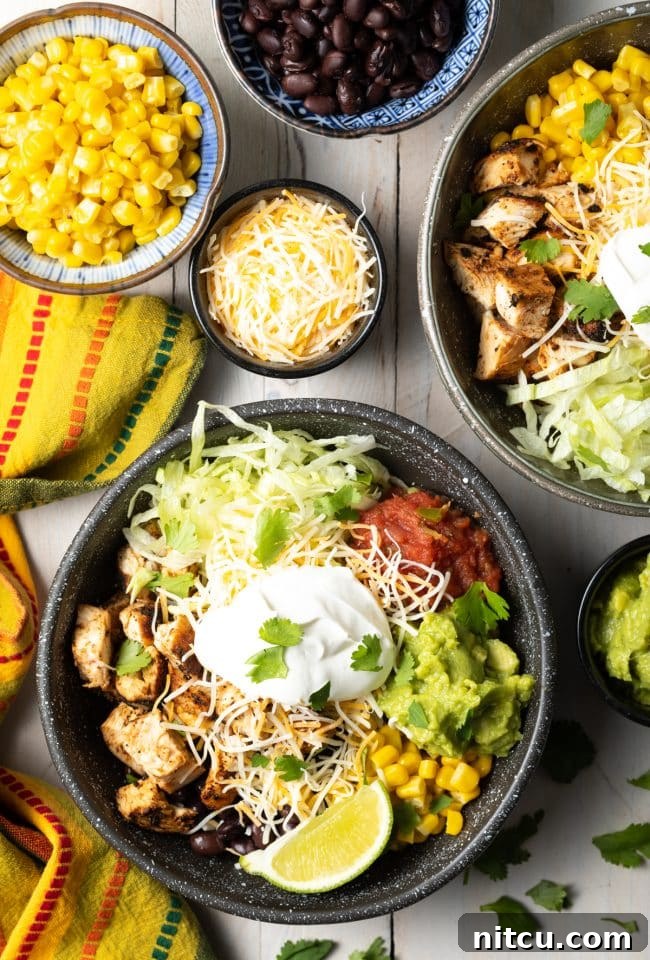 Homemade Chipotle Meal Prep Bowls 3 Assortment of fresh Southwestern toppings for burrito bowls, including salsa, guacamole, corn, beans, and shredded lettuce.