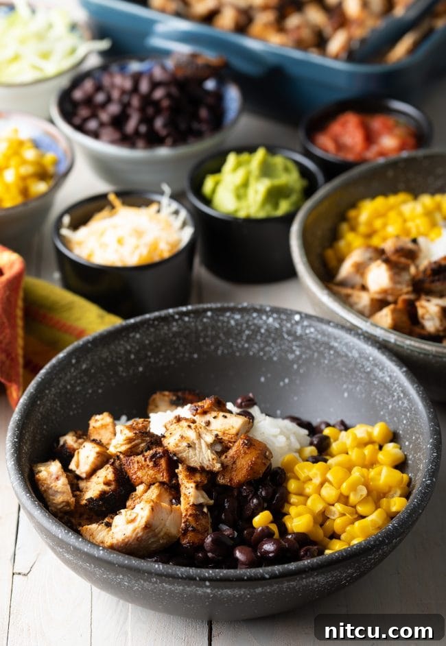 Homemade Chipotle Meal Prep Bowls 9 Step-by-step image showing how to layer ingredients into a burrito bowl, starting with rice and chicken.