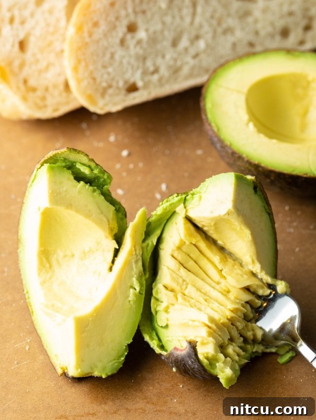 Step-by-step image of mashing avocado on toast