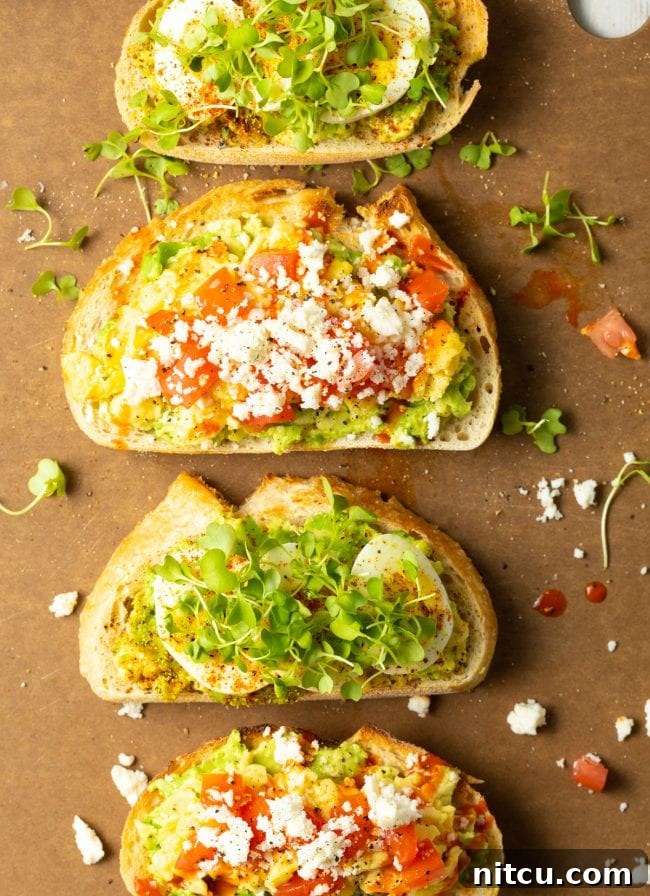 Delicious avocado toast with egg and a variety of colorful toppings