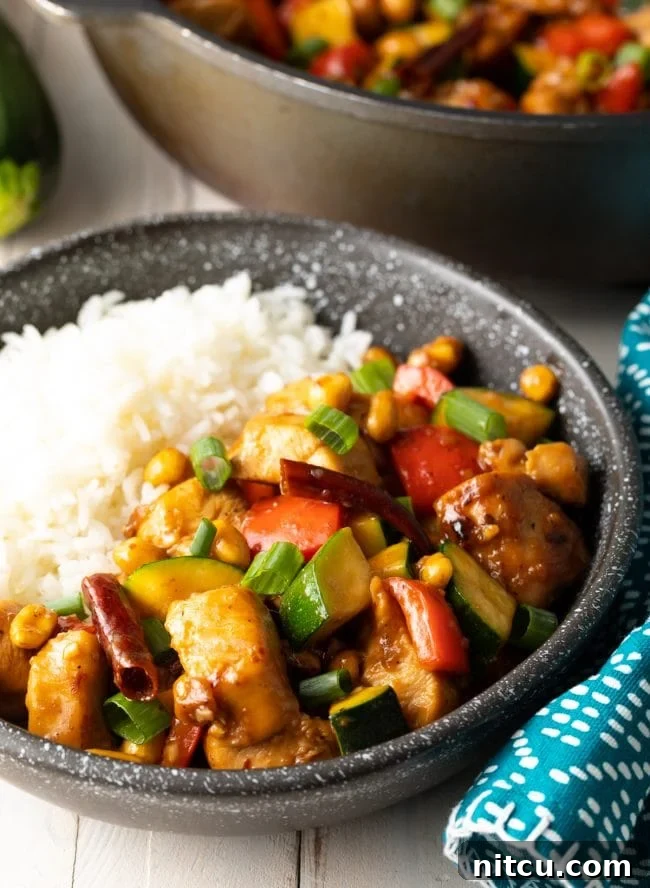 Sichuan Kung Pao Chicken 2 Black bowl served with some white rice and the best kung pao chicken recipe