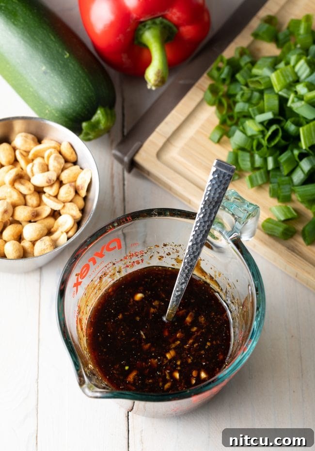 Sichuan Kung Pao Chicken 7 Glass measuring pitcher with stir fry sauce.