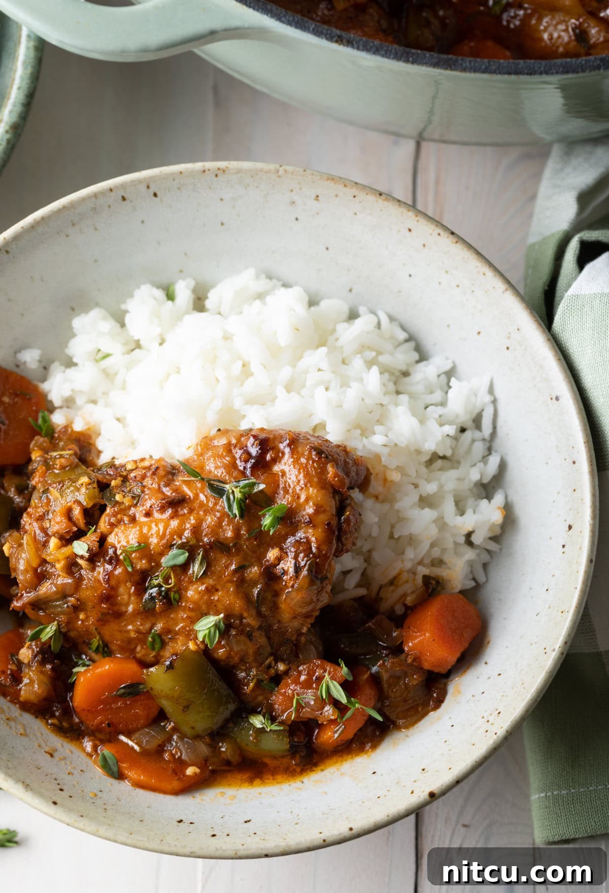 Authentic Jamaican Brown Stew Chicken 2 Jamaican brown stew chicken recipe with rice in a bowl