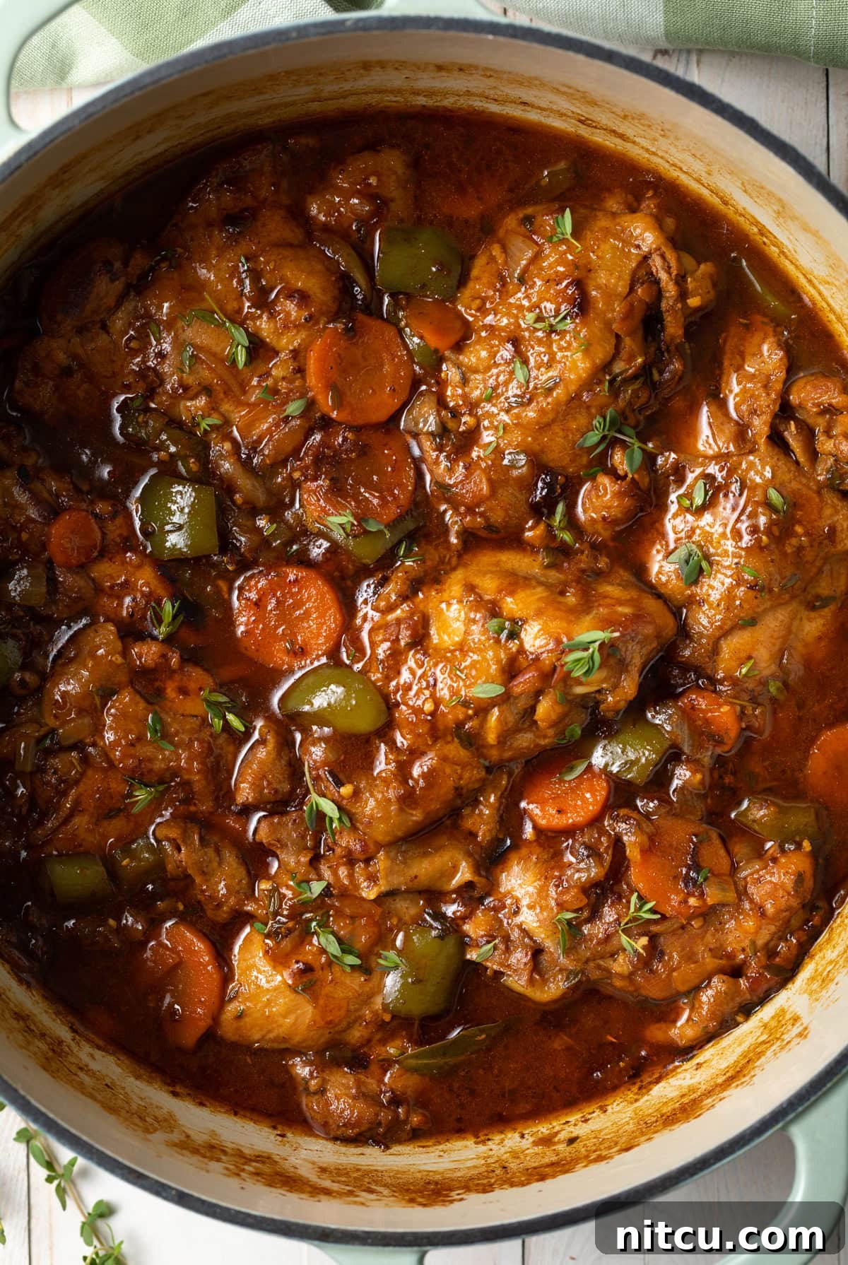 Authentic Jamaican Brown Stew Chicken 3 Top down view of a pot filled with tender chicken stew.