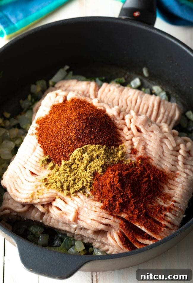 Dynamite Turkey Tacos 5 Ingredients for ground turkey tacos simmering in a skillet