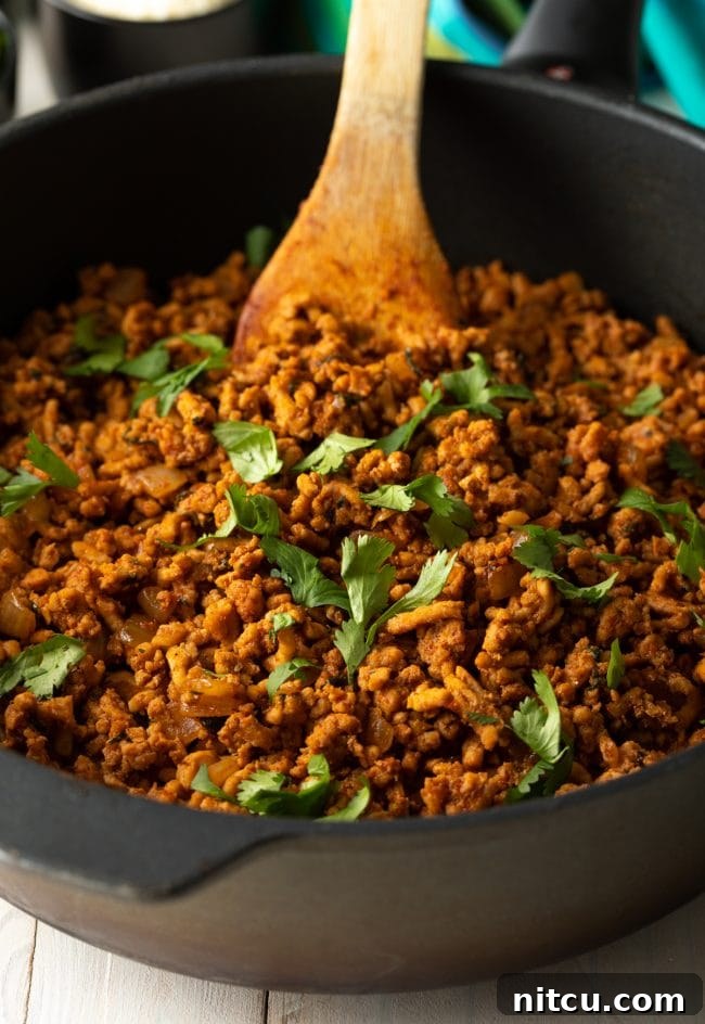 Dynamite Turkey Tacos 6 Fresh cilantro on turkey taco meat simmering in a skillet