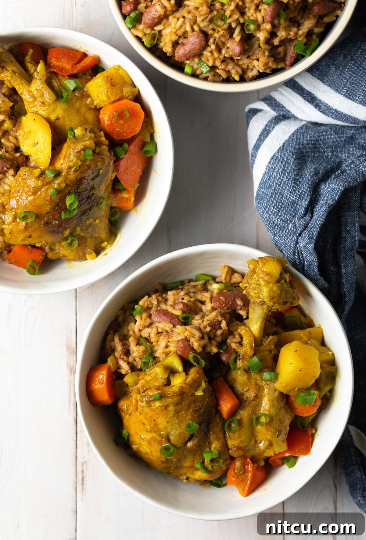 Jamaican Curry Chicken Delights 3 Bowls of yellow chicken curry with vegetables, ready to be served.