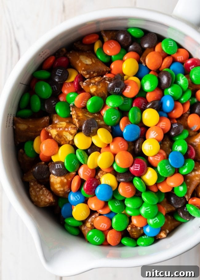 Wholesome DIY Trail Mix 7 Indulgent trail mix in a white bowl, featuring a rich assortment of treats.