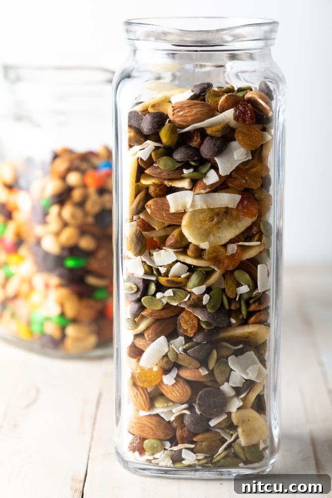Wholesome DIY Trail Mix 9 Homemade trail mix recipe with banana chips, coconut, nuts, and seeds in a beautiful glass jar, ready for sharing or snacking.
