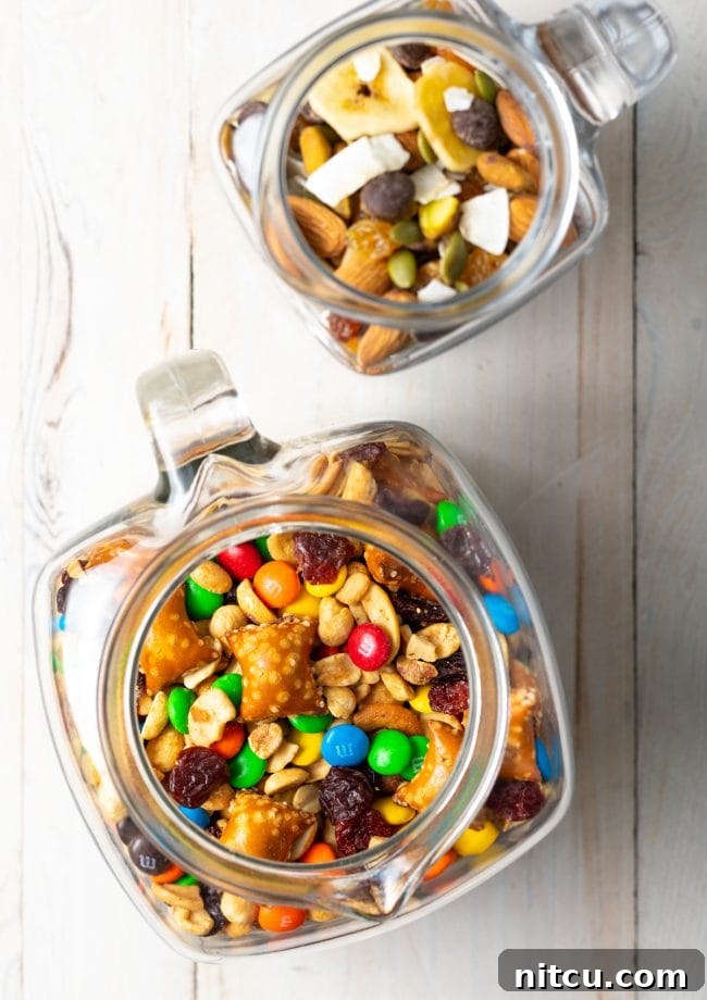 Wholesome DIY Trail Mix 10 Overhead view of homemade trail mix beautifully arranged in clear glass jars, highlighting various ingredients.