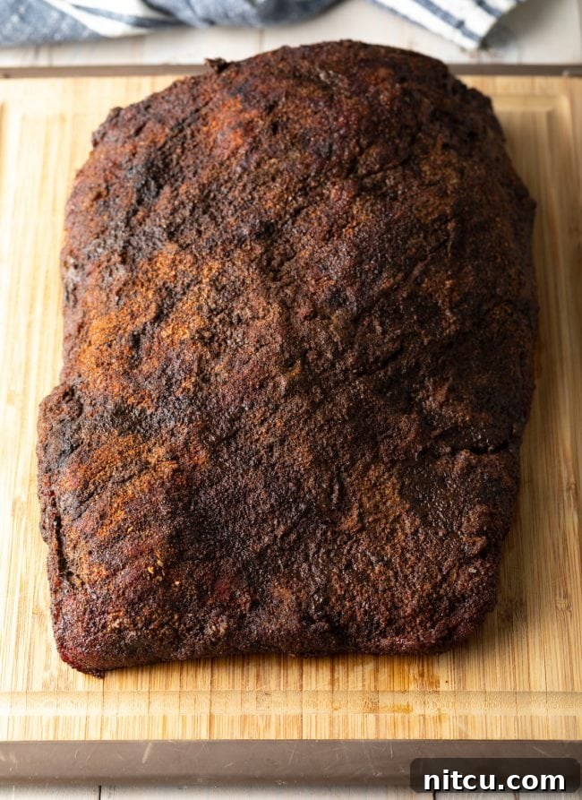 Ultimate Dry-Brined Smoked Brisket 10 Beef brisket after being smoked and before being sliced, showcasing its perfect bark.