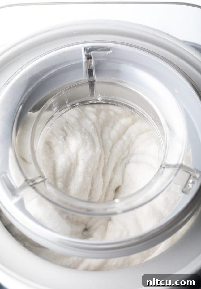 Creamy Dairy-Free Coconut Ice Cream 9 churning dairy-free ice cream in a machine