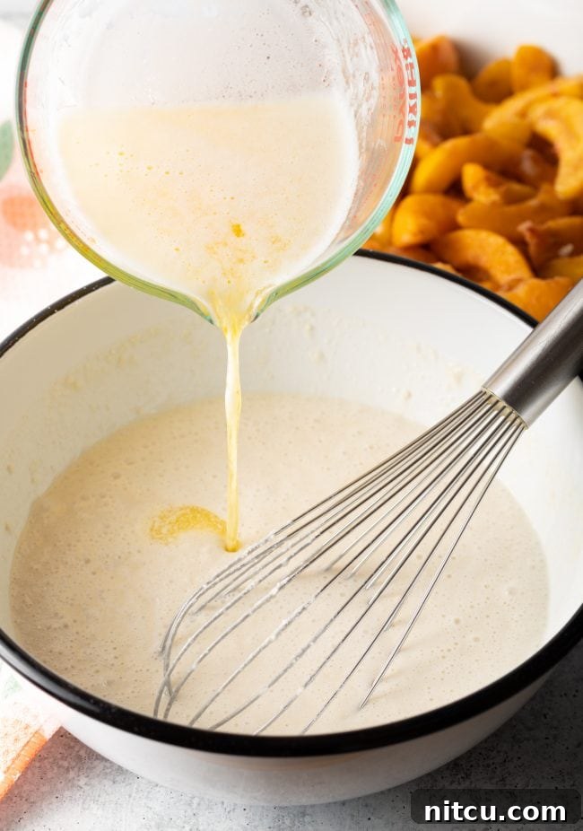 Easy Bisquick Peach Cobbler 6 whisking melted butter into the batter