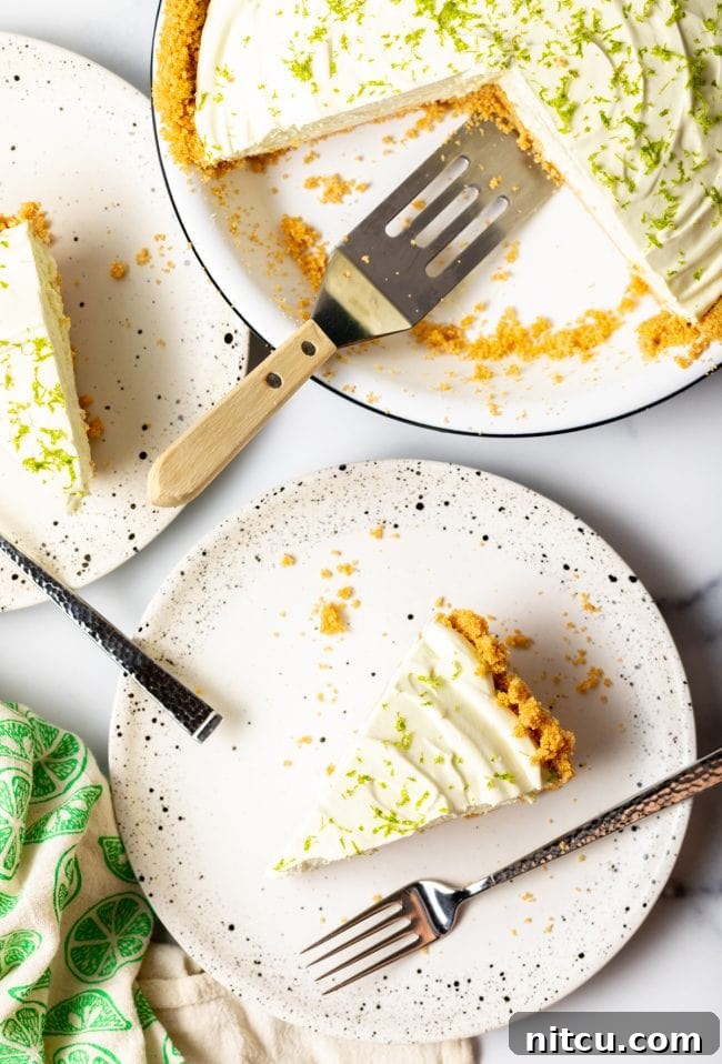 Effortless Key Lime Pie 12 An overhead view of several perfectly cut slices of icebox lime pie arranged artfully on plates, highlighting the creamy filling and crisp crust.