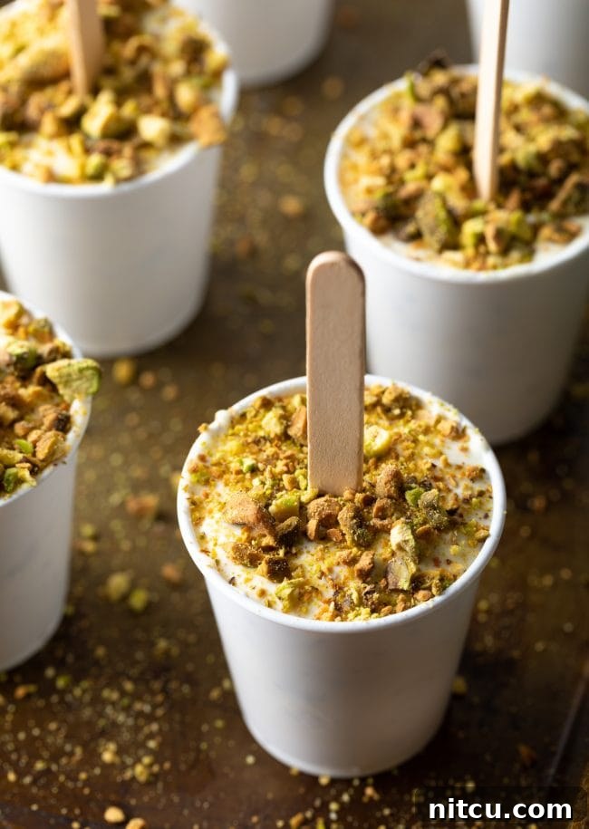 Indian ice cream pop with crushed pistachios around the bottom