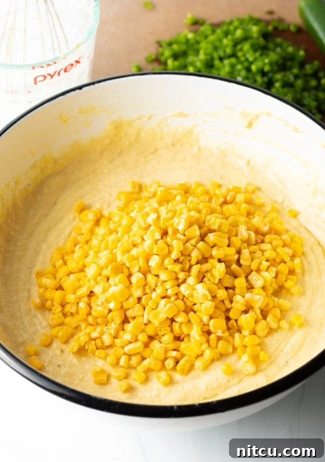 Zesty Jalapeno Cheddar Cornbread 8 Mixing buttermilk, eggs, and melted butter into the dry cornbread ingredients.