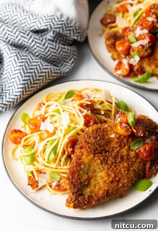 Crispy Italian Chicken Cutlets 8 finished plate of pan fried or oven baked crispy Italian chicken cutlets with pasta and cherry tomato sauce on the side