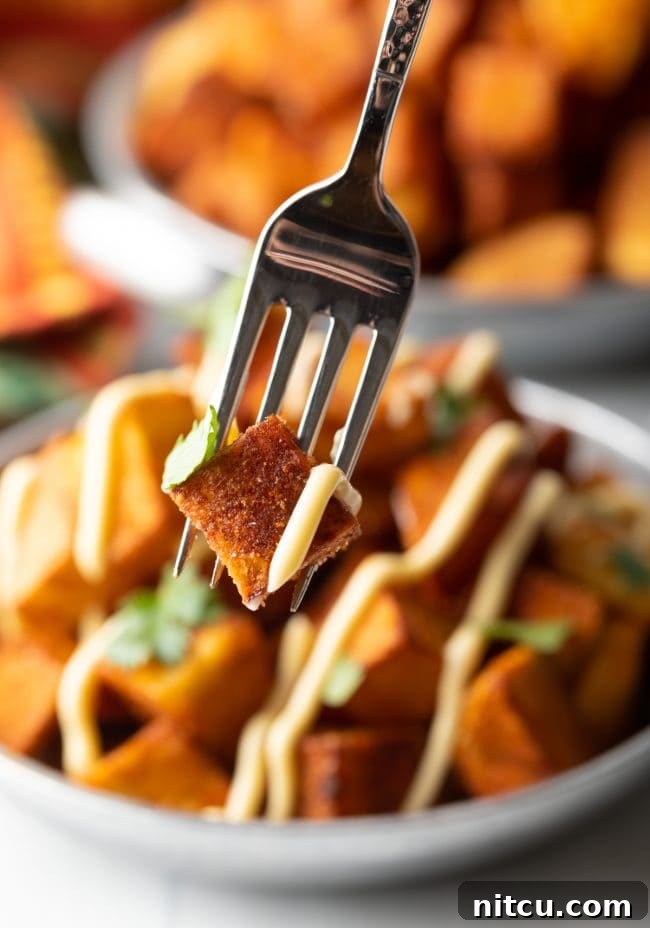 Fiesta Potatoes 4 Fork holding a single crispy Mexican fried potato with a hint of sauce and cilantro