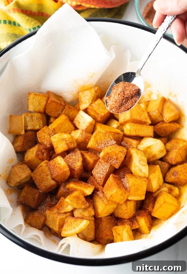Fiesta Potatoes 9 Tossing the freshly fried Papas Bravas in Mexican spices in a bowl