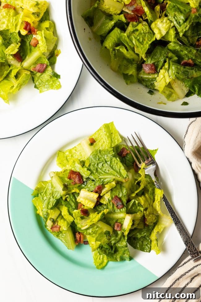 Sad Greens 2 top view two plates with southern lettuce salad with a form and salad bowl in the background