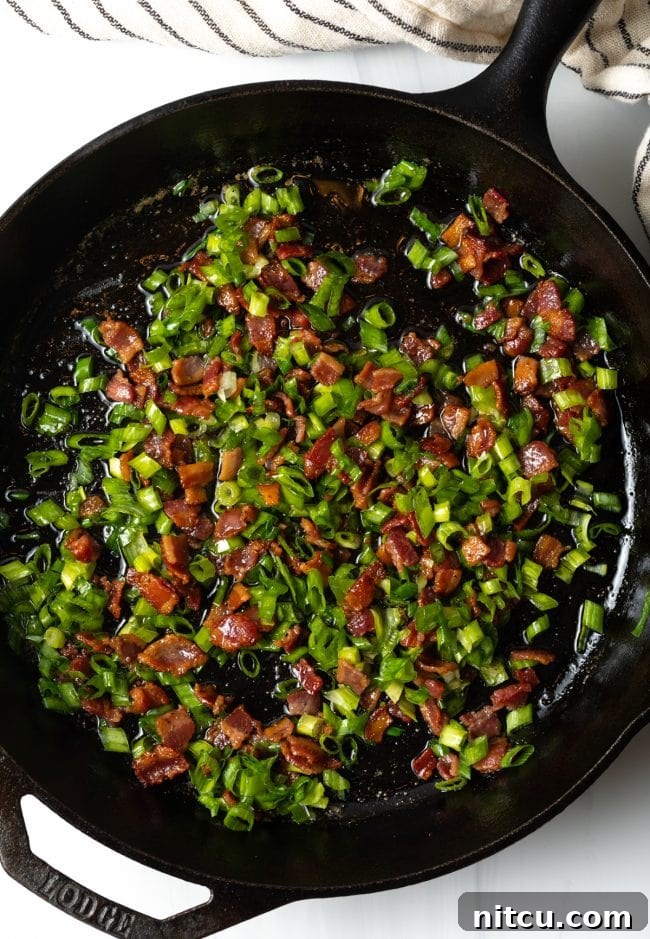 Sad Greens 7 skillet with cooked chopped bacon and sliced green onions