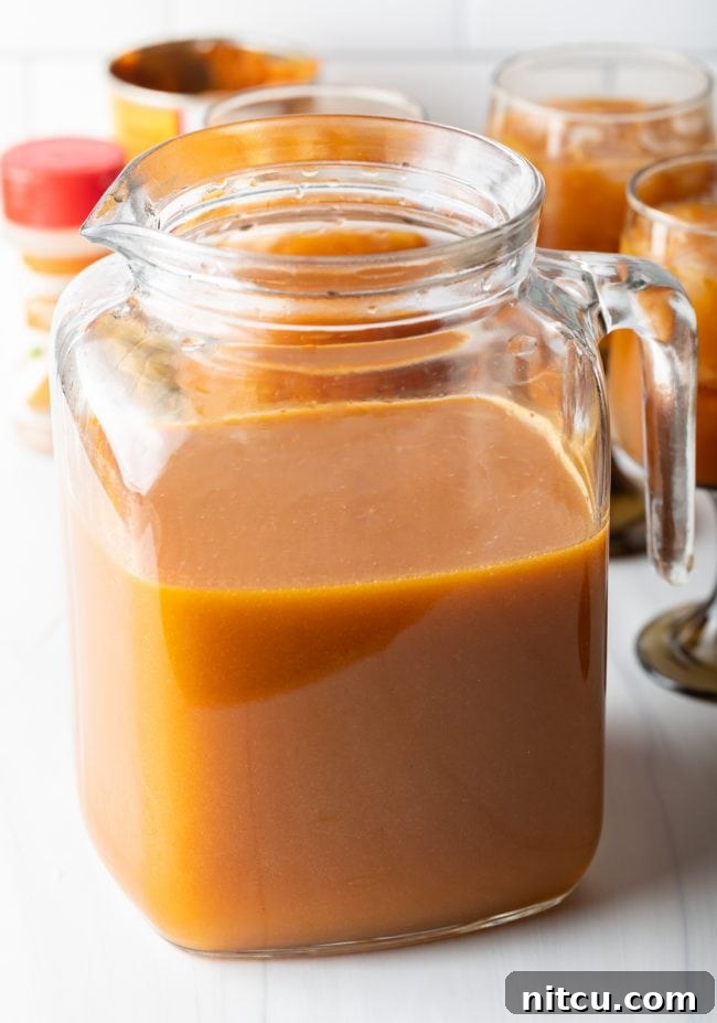 Hogwarts Pumpkin Juice 7 glass pitcher half filled with orange liquid
