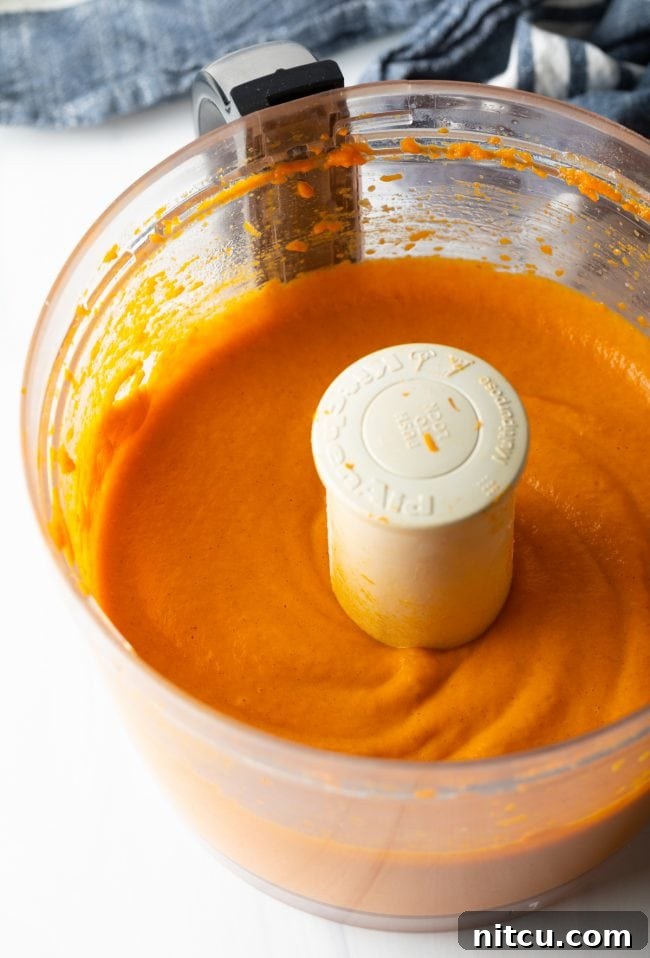 Golden Carrot Cloud 5 orange souffle mixture in a food processor