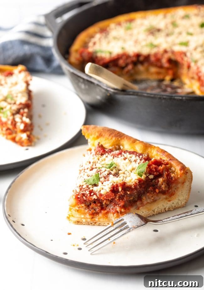 Iron-Clad Deep Dish Delight 12 A delicious slice of tomato pie with a fork on a plate, a bite already taken, showing the gooey cheese and rich tomato sauce within the thick crust.