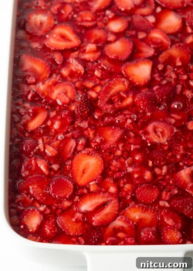 Sweet Strawberry Pretzel Delight 12 Top view of a chilled and solidified strawberry jello salad, ready to be served.
