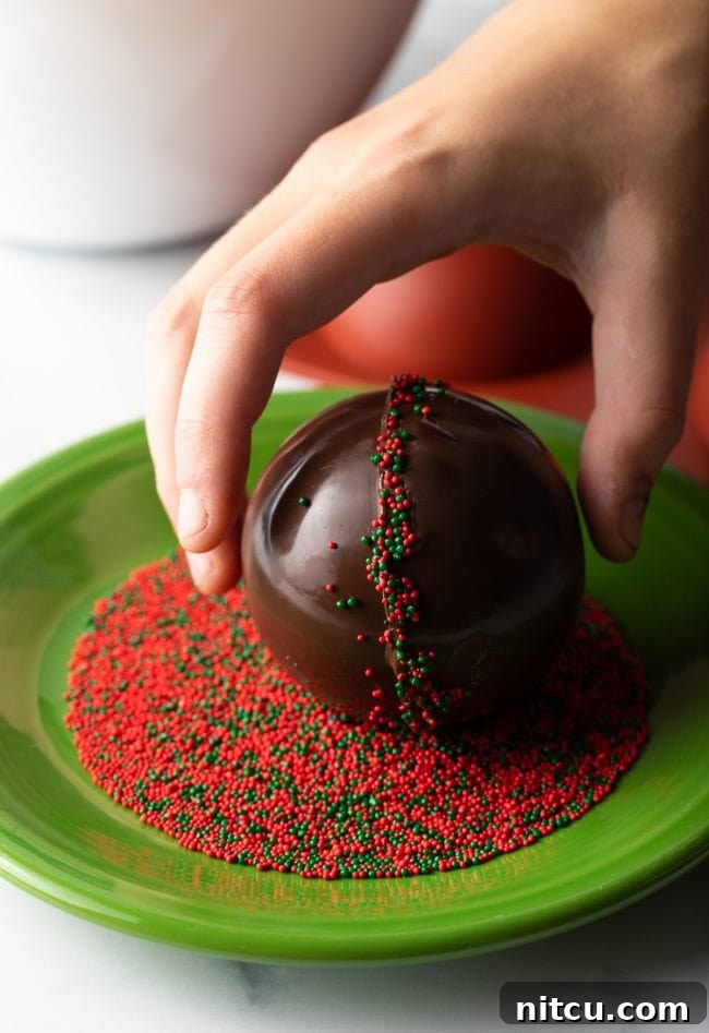 Magical Melting Cocoa 11 Hand rolling chocolate spheres into sprinkles.