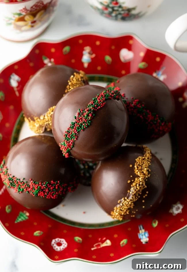 Magical Melting Cocoa 4 Top view decorated cocoa bombs stacked on a Christmas plate