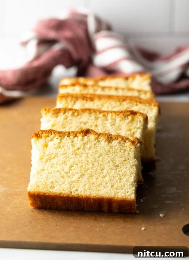 Featherlight Japanese Sponge Cake 2 slices of Japanese sponge cake on a brown cutting board, all leaning on each other