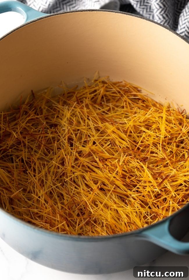 Mexican Fideo Noodle Bowl 5 broken fideo pasta browning in a large pot, showing the crucial toasting step