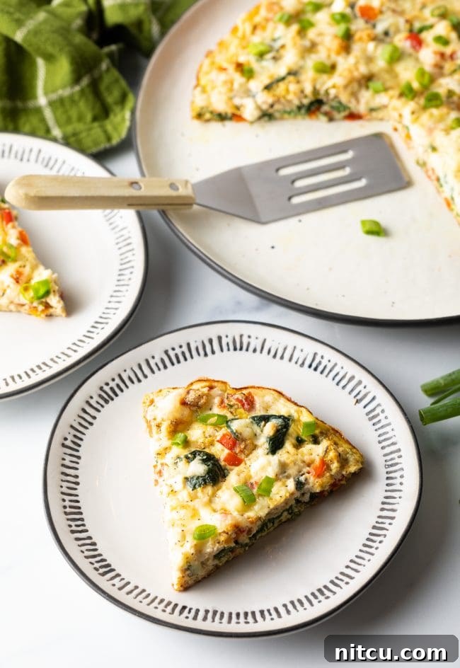 Single slice of low carb frittata with egg white and veggies on a plate