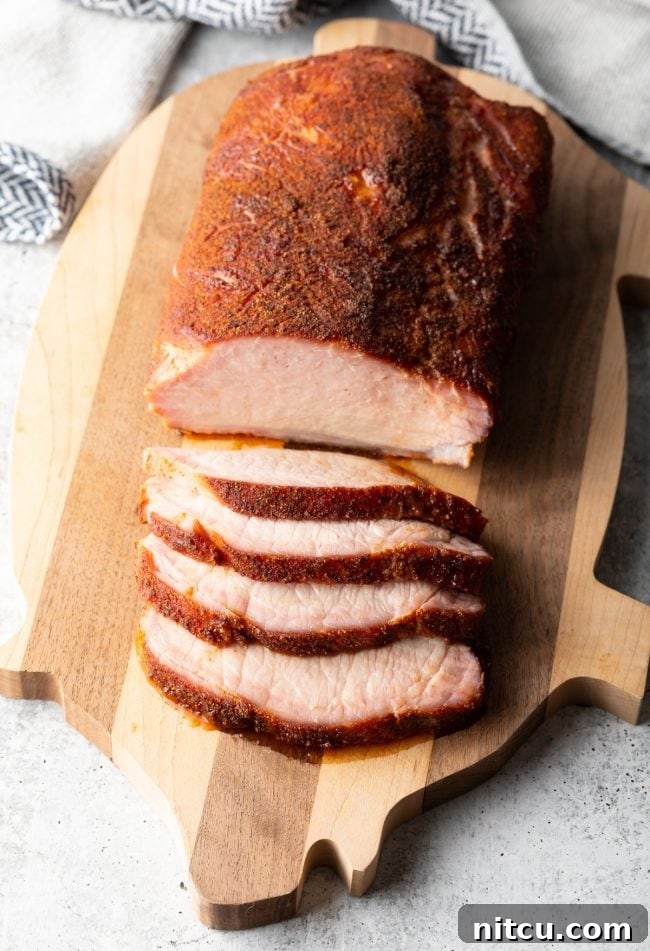 Smoked Pork Loin Rub - top view sliced loin on a cutting board