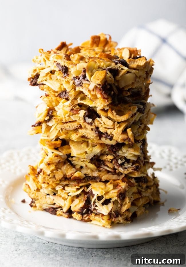 Stack of low carb cereal snack bars on a white plate, ready to be enjoyed.