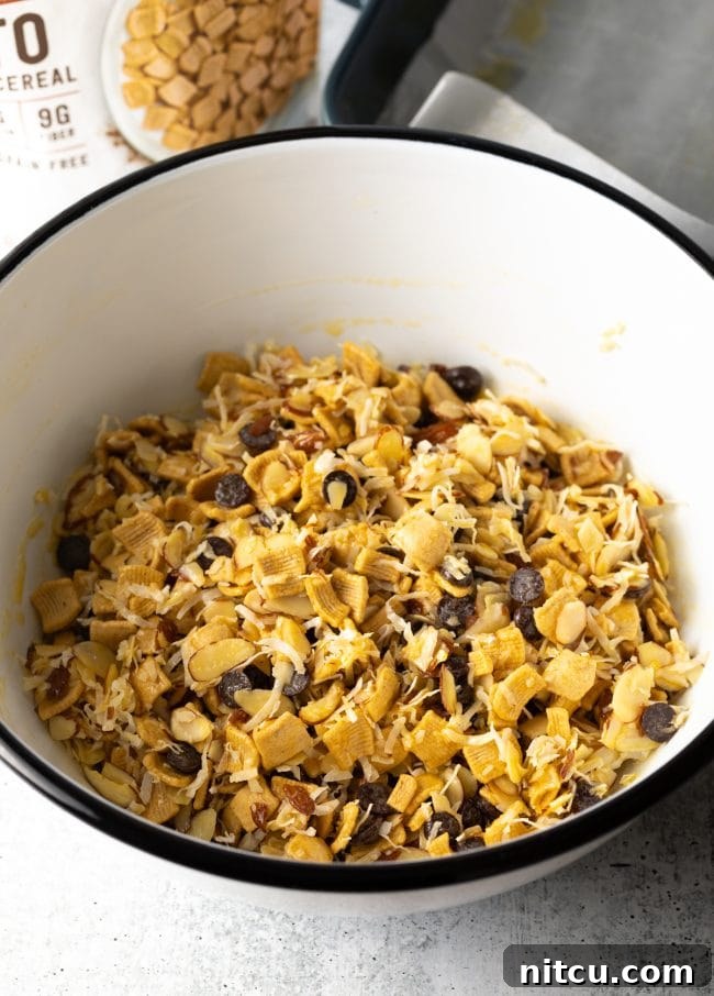 White bowl with keto cereal mix thoroughly coated in the egg mixture.