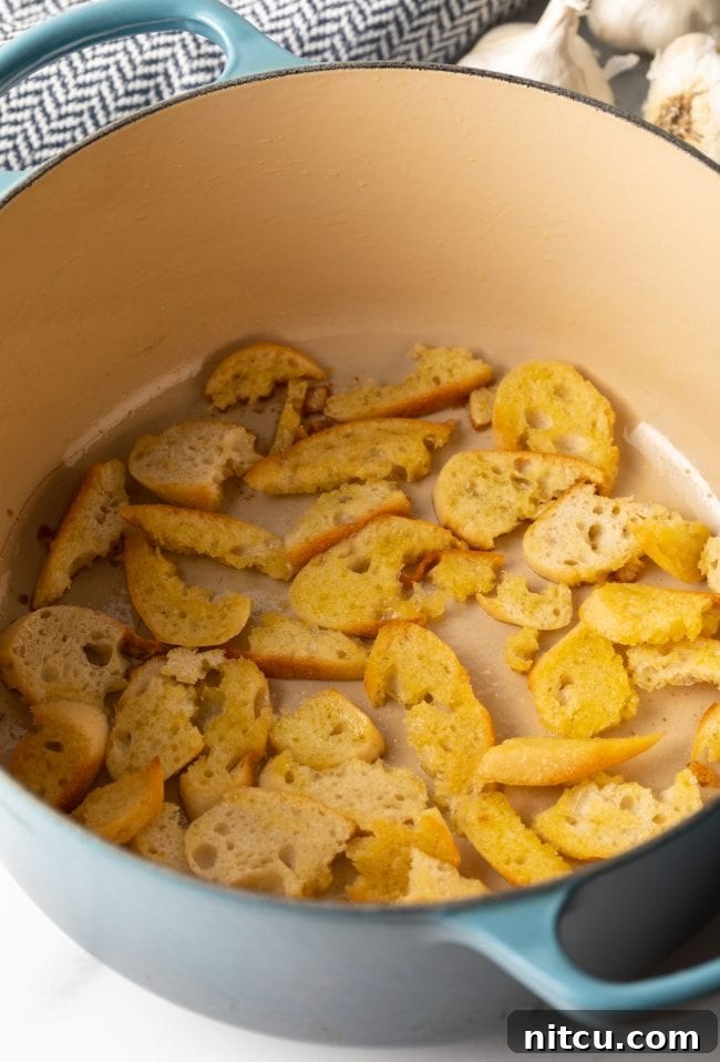 Rustic Spanish Garlic Soup 6 slices of baguette toasted with oil in a large pot