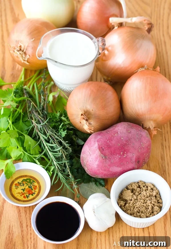Ingredients for Cream and Onion Soup Recipe laid out: fresh cream, yellow onions, russet potatoes, garlic, bay leaves, thyme, honey, balsamic vinegar, and beef base paste.