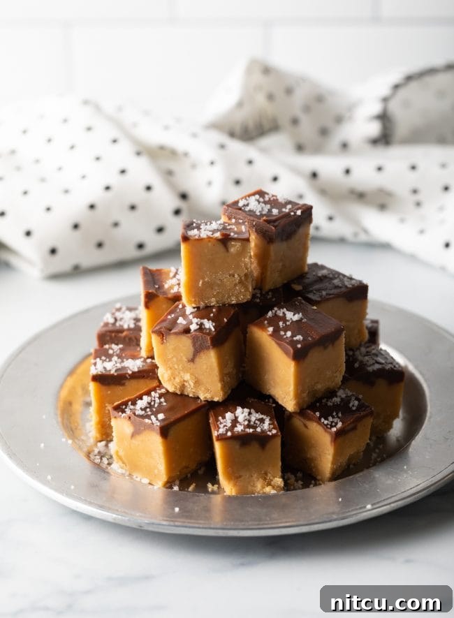 Peanut Butter Delights 3 Pulled-out view of neatly stacked pieces of homemade Peanut Butter Fudge on a silver plate, ready to be served.