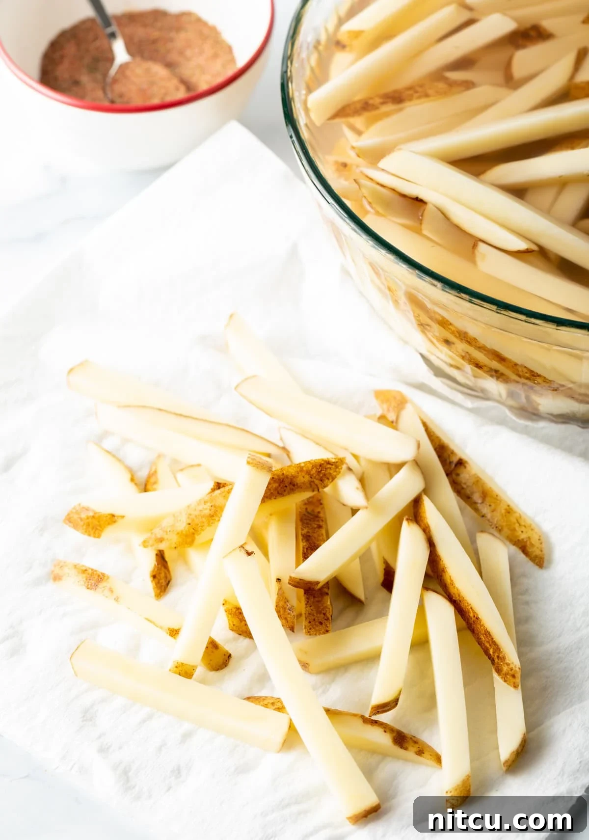 Cajun Fries: Homemade Seasoning Blend Recipe 5 Sliced potatoes on a white towel.