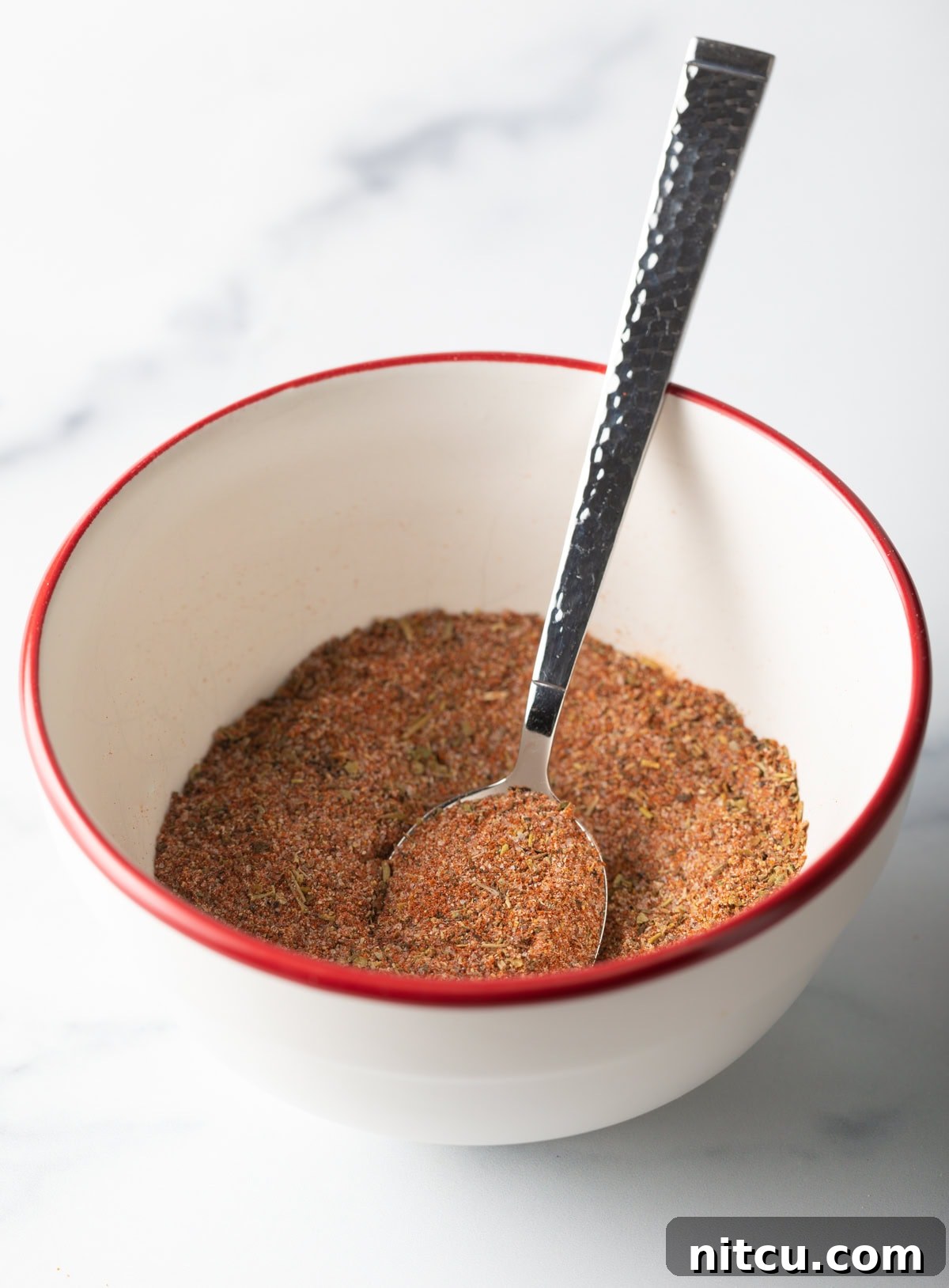 Cajun Fries: Homemade Seasoning Blend Recipe 8 Spoon mixing spices together.