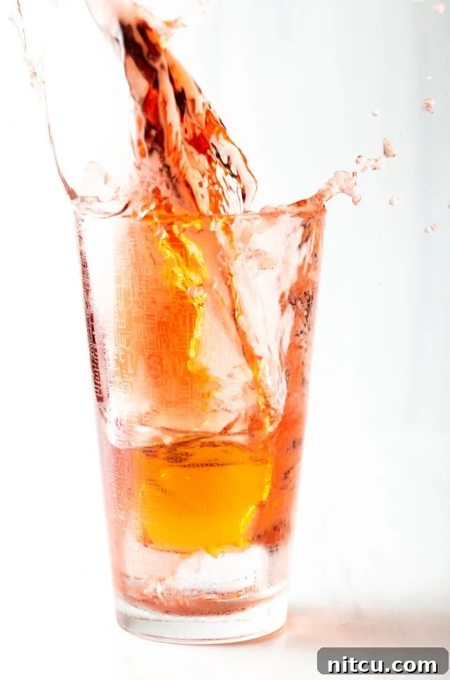 Sin City Slam 3 Closeup of a shot of red bull splashing into a Vegas Bomb glass.