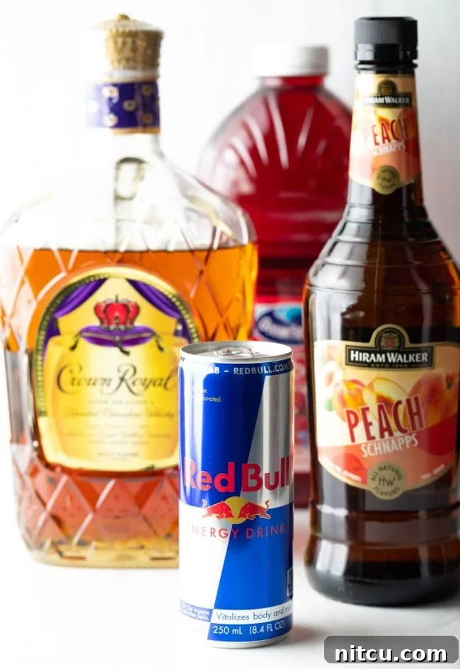 Sin City Slam 4 Closeup shot of Vegas Bomb drink ingredients. You see the bottles of Red Bull, peach schnapps, Crown Royal and cranberry juice.