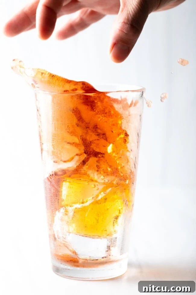 Sin City Slam 9 hand dropping energy drink shot into tall glass of juice and booze
