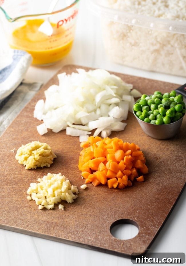 Perfect Homemade Hibachi Rice 6 Ingredients for fried rice neatly arranged on a cutting board, prepped and ready.