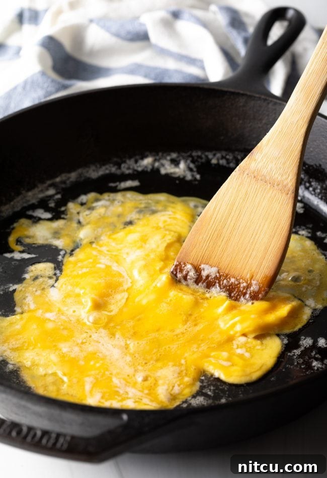 Perfect Homemade Hibachi Rice 9 Eggs being scrambled gently in a pan, fluffy and golden.
