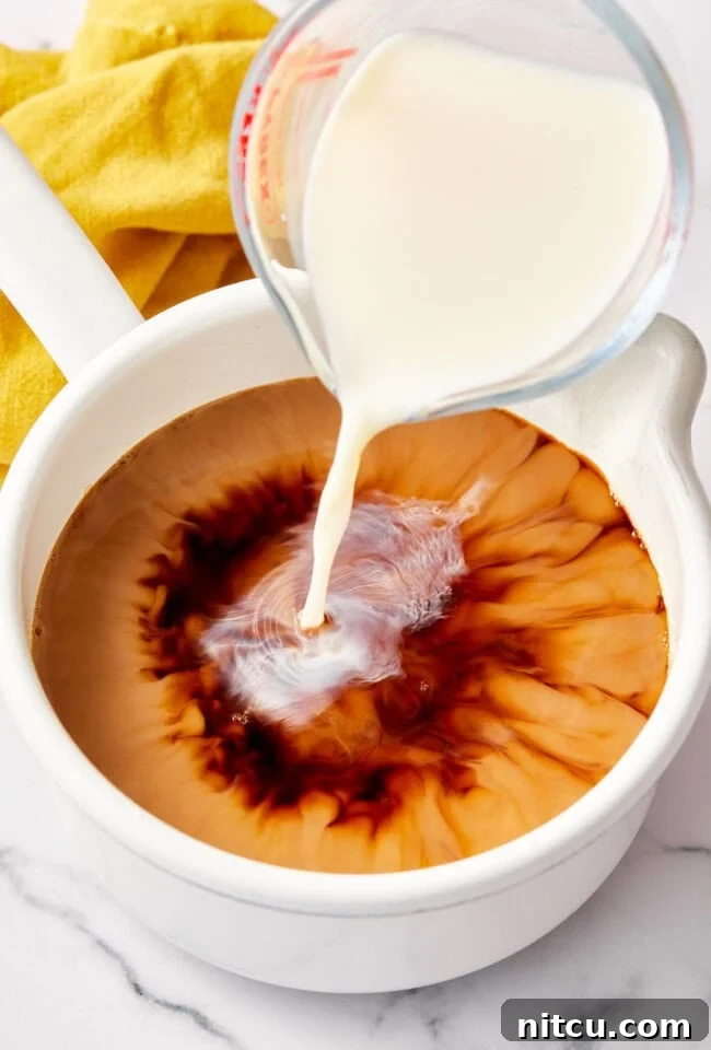 Finest Chai Tea Blends 8 Milk blending into the rich chai tea concentrate, creating a beautiful creamy texture and color for the homemade latte.