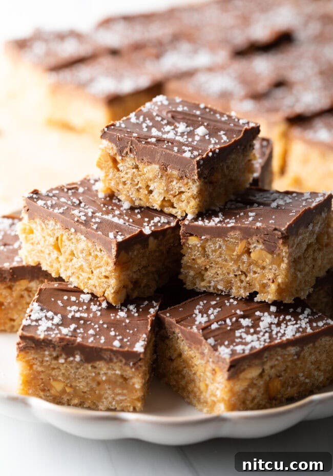 Peanut Butter Rice Krispie Treats 13 Plate stacked 3 treats high, filled with Scotcharoos.